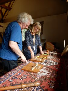 2 volunteers looking at old fashioned games