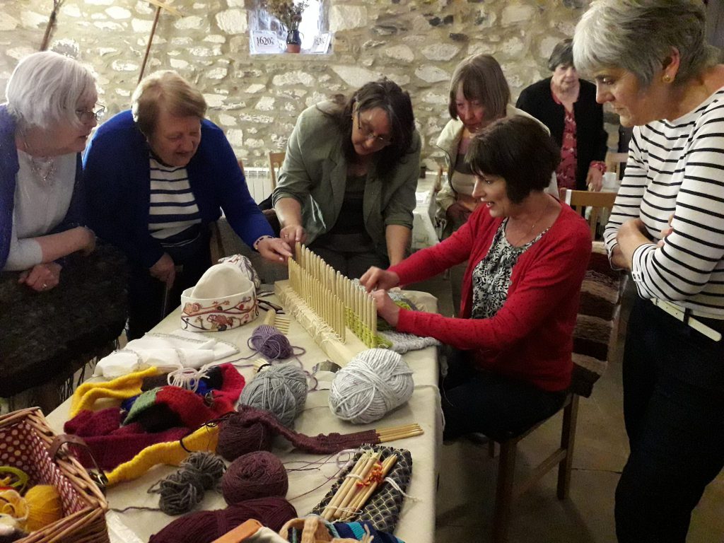 A picture of staff, friends and volunteers sharing craft skills in the barn