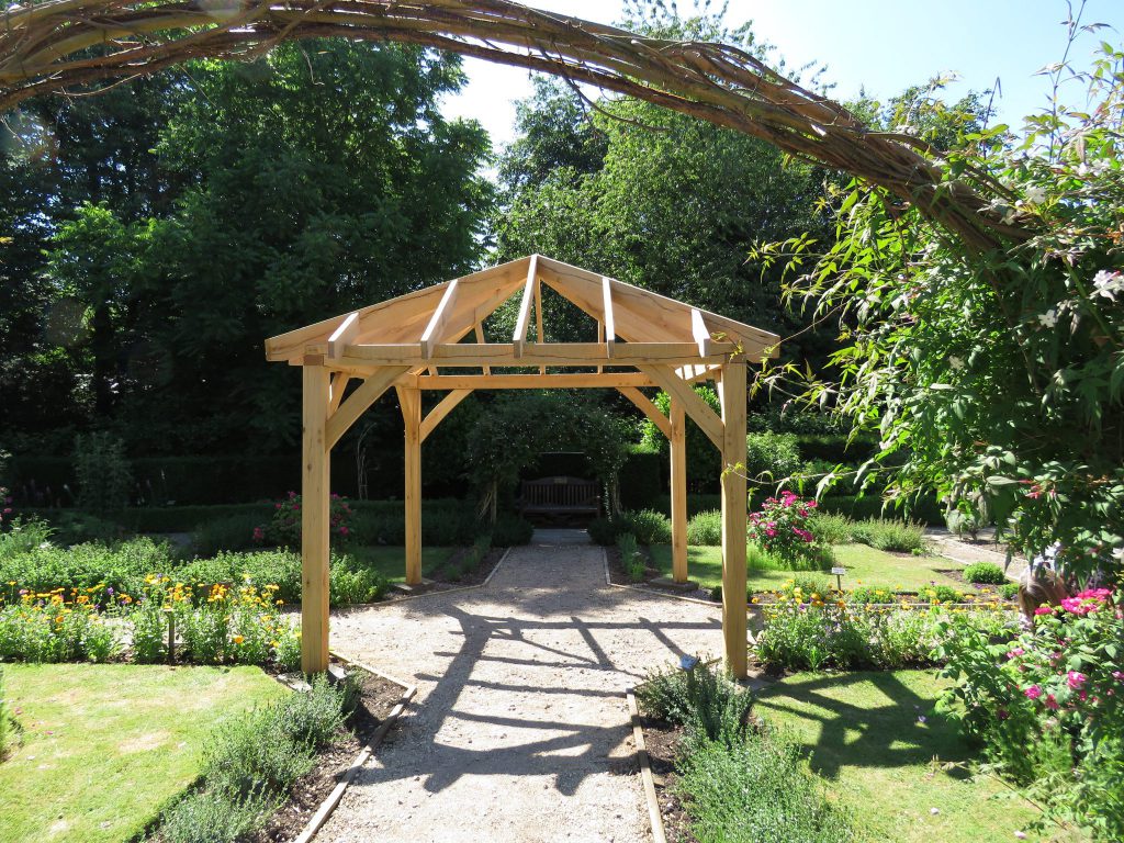 A picture of a pergola in the garden near the Old Barn Cafe